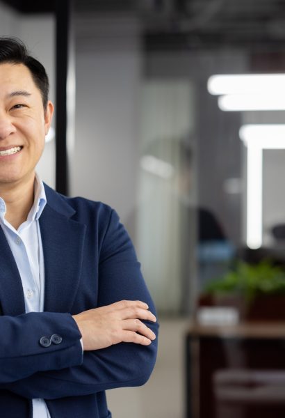 Portrait of successful asian businessman inside office at workplace, man in business suit smiling looking at camera, mature boss with crossed arms, successful financier broker.