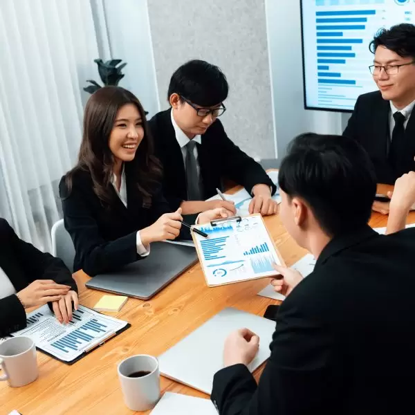 Business team of financial data analysis meeting with business intelligence, report paper and dashboard on laptop for marketing strategy. Business people working together to promote harmony in office.