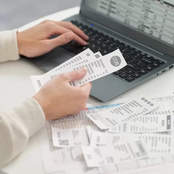Hand of a man entering expenses into accounting software